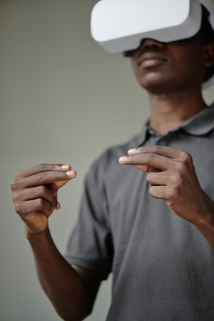 Low angle shot of African American male hands gesticulating in air during VR gameの写真素材