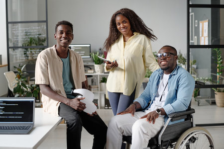African American office workers posing for portrait together while they in office of IT companyの写真素材