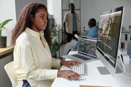 African American woman focused on programming, she writing codesの写真素材