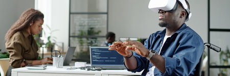 Website banner of African American man with disability playing VR game and gesticulating during processの写真素材