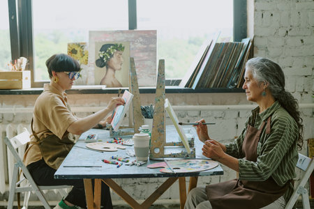 Side view shot of senior silver haired mom and her young adult brunette daughter sitting at retro...