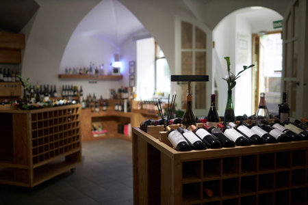 Ample dimly lit room with wooden wine cabin and rack prepared for upcoming degustation