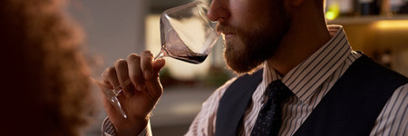 Website banner with medium close up shot of unrecognizable sommelier smelling wine aroma from special crystal glassの写真素材