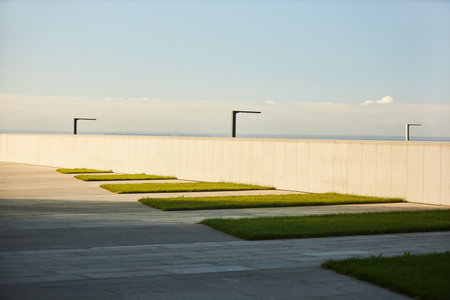 Modern walkway design emphasizing clean, geometric lines and minimalistic lighting features seen in outdoor urban environmentsの写真素材