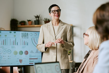 Caucasian middle aged woman presenting business data to group of middle aged and senior women in...