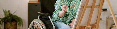 Website banner with Caucasian young adult woman with disability sitting in wheelchair painting on...