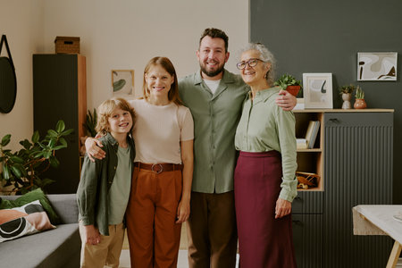 Caucasian boy, young adult woman, man, senior Caucasian woman standing together smiling in modern...