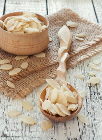 Wood spoon and bowl with almond flakesの写真素材