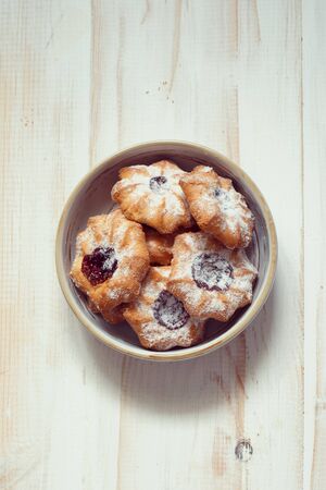 Biscuit chip cookies with jam on a painted white wooden background. Flat layの写真素材