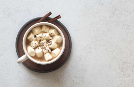 Cup of coffee and white marsmallows on gray stone background. Flat layの写真素材
