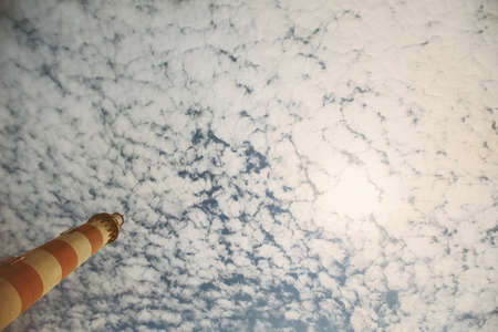 Lighthouse top on sky and clouds backgroundの写真素材