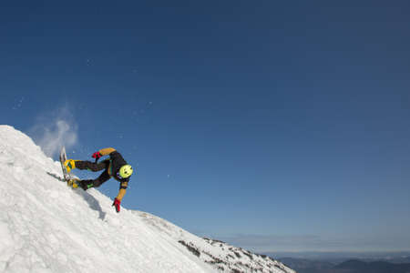 Snowboarder falling down in snow mountain