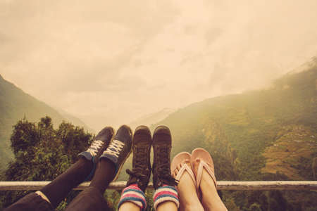 Friends legs outdoor on mountain background. Travel togetherの写真素材