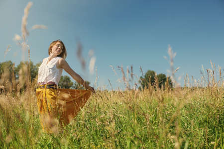 Free Happy Woman Enjoying Nature. Beauty Girl Outdoor. Freedom concept. Beauty Girl over Sky and Meadowの写真素材