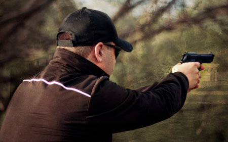Man aim a gun with two hands. Airgun shooting