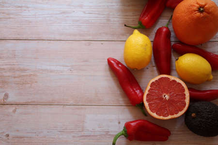 fruit and vegetables placed on wood, melon cut, red pepper, grapefruit cut, fresh vitaminsの写真素材