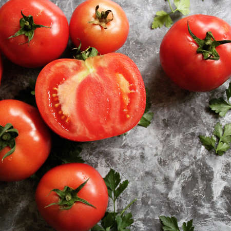 Fresh red tomatos vegetables on tableの写真素材