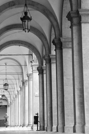 black and white photo, arcades under a tenement house in an Italian cityのeditorial素材