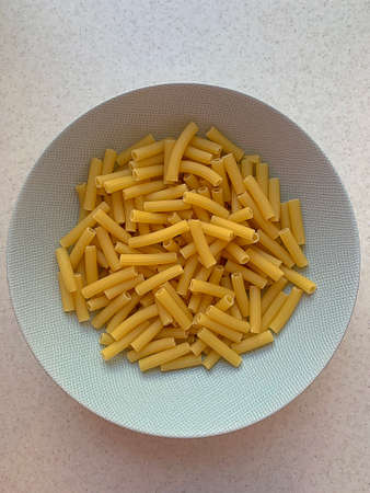 white pasta plate, grano duro pasta, long thin tubes, Italian pasta