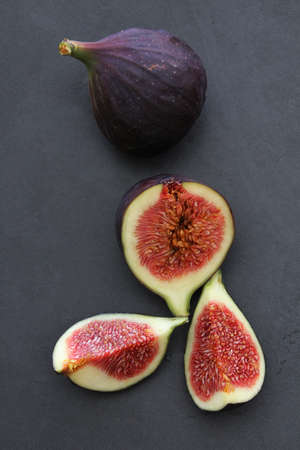 small pieces of cut figs, fig cut into quarters, fruit with a lot of pips, fig on a gray background, Mediterranean fruit, purple figの写真素材