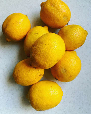 stacked whole lemons, peel on citrus, yellow lemons stacked in a pile, sour fruit, fresh vitaminsの写真素材