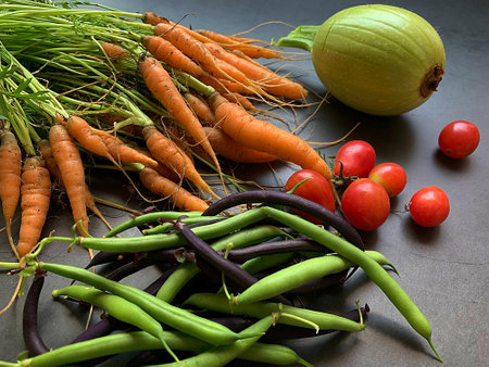small carrots, green and purple green beans, round courgette, small tomatoes, harvest from the...