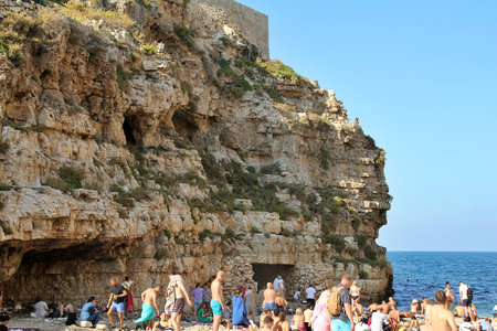 big rock on the seashore, cliff beach, rocky coast, people on the beachの写真素材