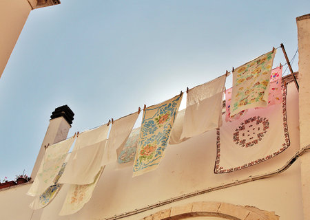 building wall with drying tablecloths, laundry hung out to dry, tablecloths and cloths hangingの写真素材