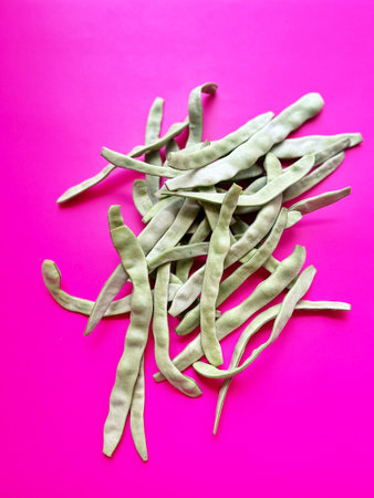 green broad beans, pink background, beans picked in the garden, green vegetables, healthy food