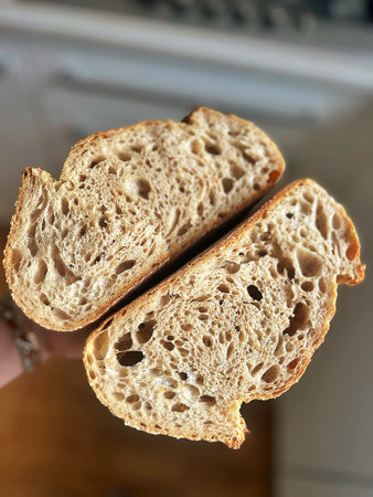 fresh artisan bread, sourdough bread, crusty bread, sliced loaf of bread, slices of bread, buttered...