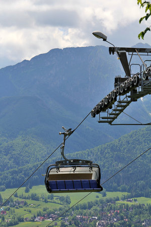 Cable car on the background of mountains and sky in the summer, cable car, ski lift in the...