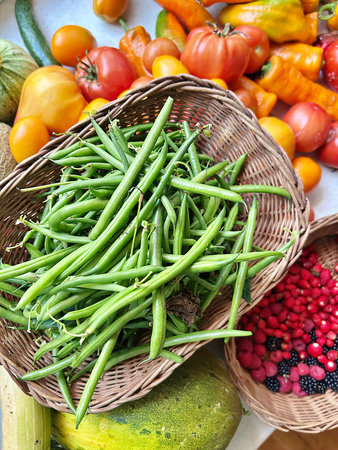 colorful vegetables, vegetables and fruits collected on the plot, green beans in a basketの写真素材