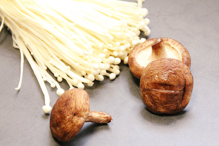 Mushroom and Enoki mushroom on black background. Healthy food.