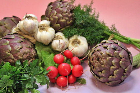 vegetables on a table in a restaurant with a pink backgroundの写真素材