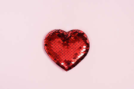 One red heart on pink and black paper background for valentines day