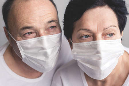 Seniors man and woman in medical masks close up of faces Wearing medical mask to prevent coronavirus covid 19の写真素材