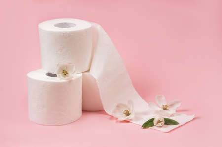 Rolls of toilet paper on a yellow background top viewの写真素材