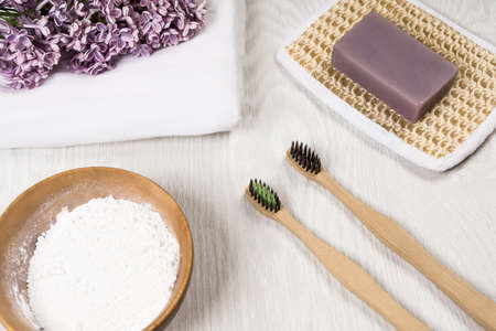 Eco-friendly bamboo toothbrushes, handmade soap, tooth powder, linen cloth on a wooden background. Zero waste concept. Sustainable lifestyle. Plastic free concept.の写真素材