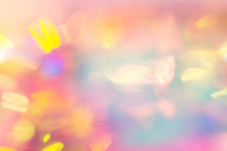 Blurred holographic background with bright rainbow sparkles. Rainbow background.