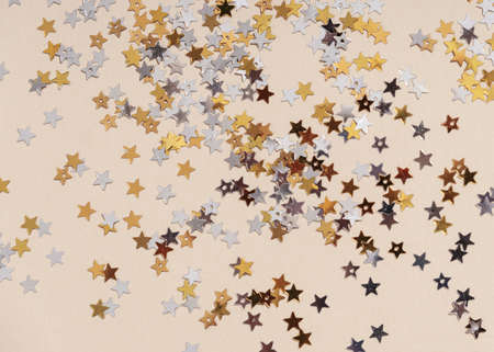 Gold stars glitter on beigeの写真素材