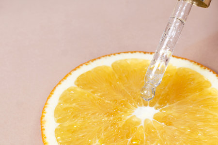 Dropper with aromatic cosmetic oil of orange. Vitamin C