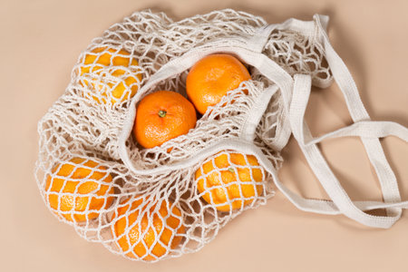 Tangerines in a knitted rag bag, string bags with tangerines, zero waste, slow life.の写真素材