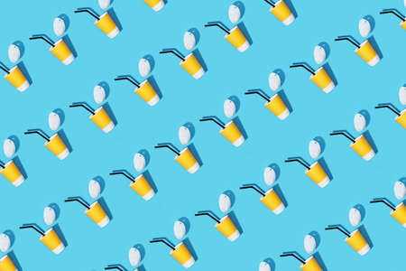 Pattern yellow cardboard coffee cup on a blue background. Flat style.