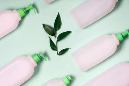 Plastic containers on a green background. Plastic and ecology recycling concept. Flat lay, top viewの写真素材