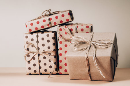 Set of various multi-colored gift boxes and Christmas coniferous branches on a light yellow backgroundの写真素材