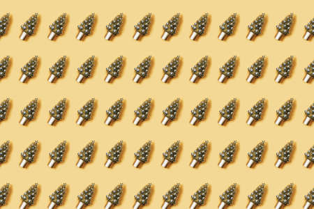 Christmas background. Pattern christmas tree decorated with balls on a yellow backgroundの写真素材