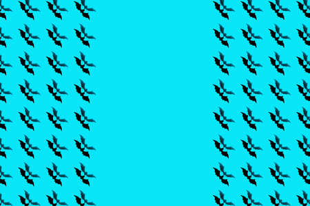 Halloween holiday concept. Pattern from paper bats on a blue background.