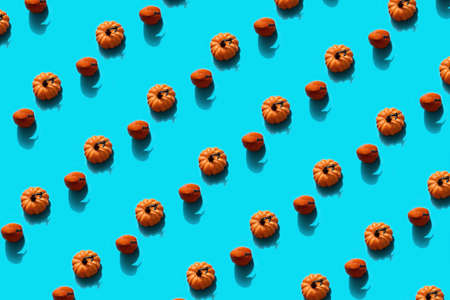 Autumn halloween holiday concept. Pattern from pumpkins. Flat lay on blue background.の写真素材