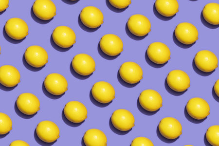 Fruit lemon in checkered pattern on violet background. Violet and yellow colors background from fruity lemon. Demonstrating very peri, color of 2022 year.の写真素材