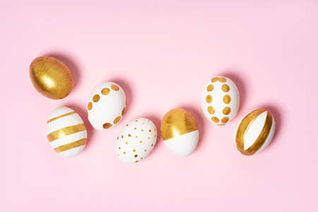 Hand-drawn easter eggs on pink pastel background. Many easter eggs flat lay background.